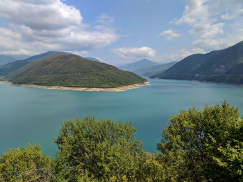 Scenic view of lake and mountains against sky