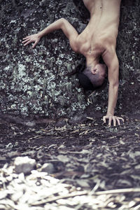 High angle view of shirtless man lying on water