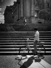 Rear view of woman with bicycle