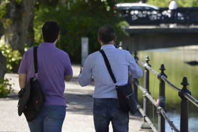 Rear view of men walking outdoors