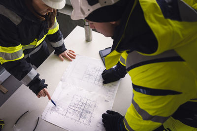 Engineers checking plans at building site