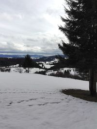 Snow covered landscape against sky