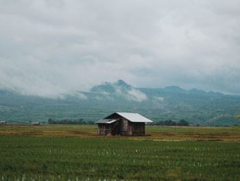 House on field against sky