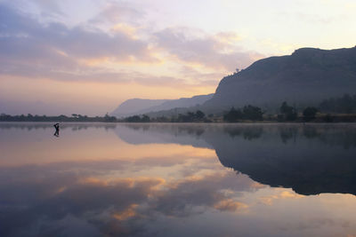 Scenic view of lake against sky during sunset