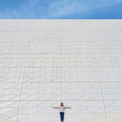 Low angle view of man walking on wall