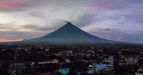 Scenic view of city against sky during sunset