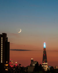 Illuminated buildings against sky at night