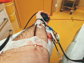 Low section of man with iv drip at home