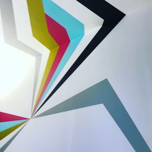 High angle view of multi colored paper over white background