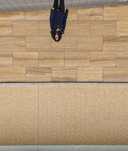 Low section of man sitting on wooden floor