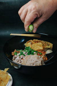 Cropped hand preparing food