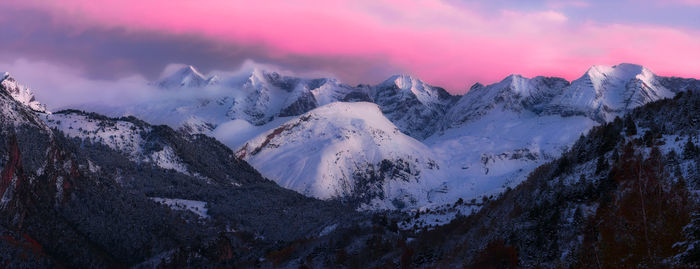 Scenic view of snowcapped mountains against sky during sunset