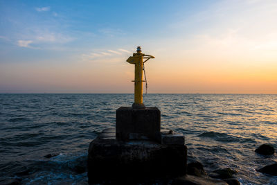 Close-up of sea against sky during sunset