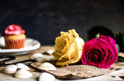 Close-up of pink roses on table