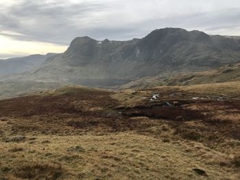 Scenic view of mountains against cloudy sky