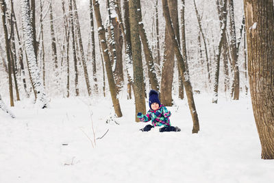 Man skiing on snow covered land