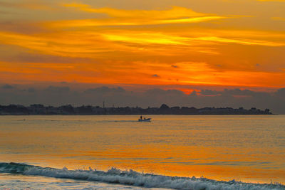 Scenic view of sea against orange sky