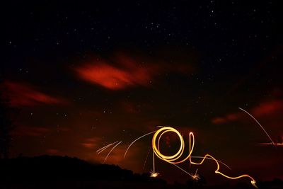 Light trails against sky at night