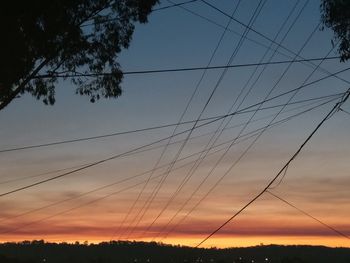 Low angle view of silhouette trees against sky during sunset