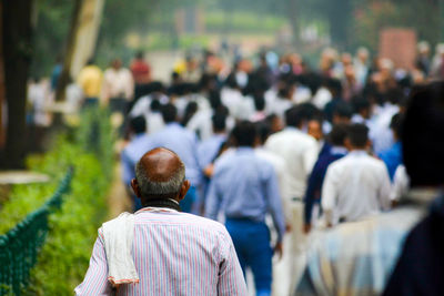 Rear view of people walking on street