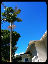 Low angle view of building against clear blue sky