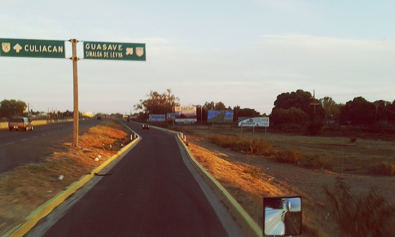 transportation, the way forward, road, diminishing perspective, vanishing point, road marking, sky, text, road sign, communication, tree, guidance, country road, empty road, street, empty, information sign, direction, western script, highway