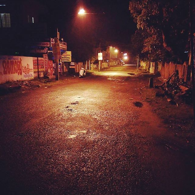 night, illuminated, street light, the way forward, street, building exterior, architecture, built structure, lighting equipment, road, city, diminishing perspective, empty, outdoors, vanishing point, transportation, dark, light - natural phenomenon, no people, cobblestone