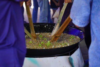 Midsection of people preparing food