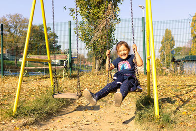 Full length of girl on slide at playground