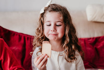 Cute girl holding biscuit