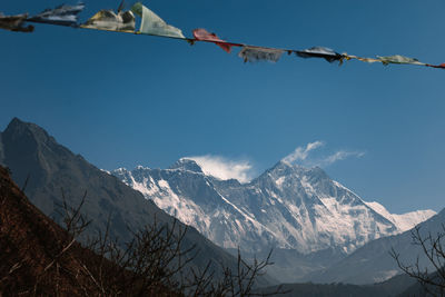 Low angle view of snowcapped mountains against sky