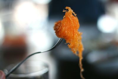 Close-up of wet orange leaf