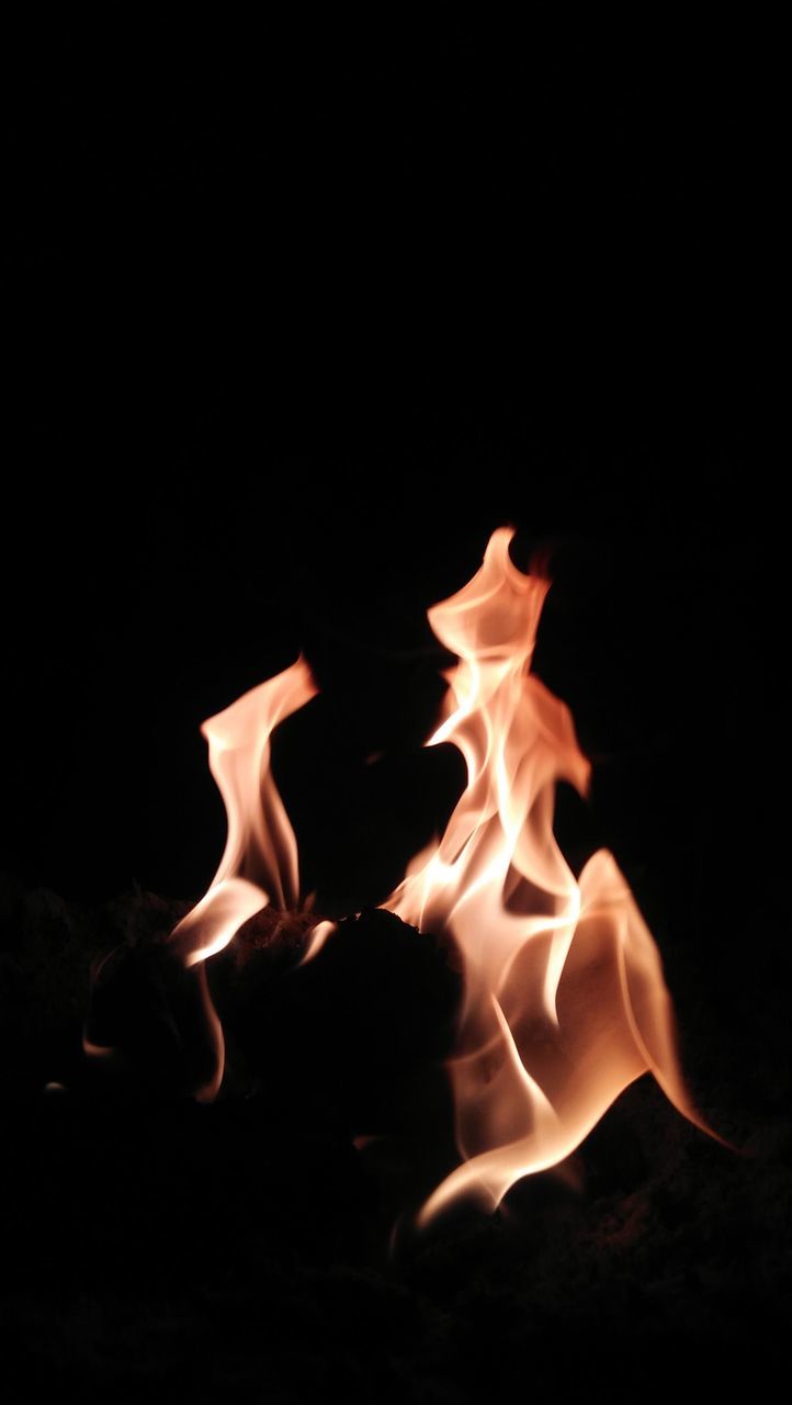 CLOSE-UP OF BURNING FIRE AT NIGHT