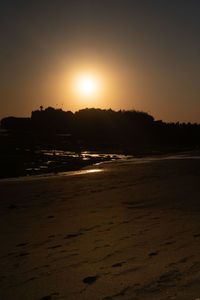 Scenic view of beach against sky during sunset