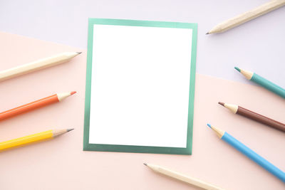 High angle view of colored pencils on white table