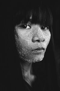 Close-up portrait of young woman with bangs