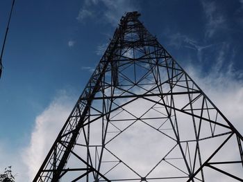 Low angle view of silhouette electricity pylon against sky