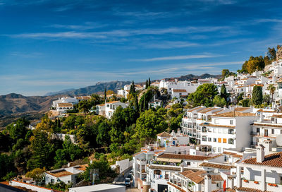 High angle view of houses in town against sky