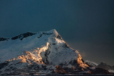 Scenic view of snowcapped mountain against sky at dusk