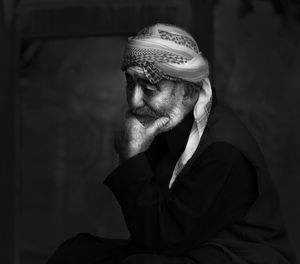 Thoughtful senior man wearing headscarf