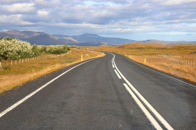 Empty road along countryside landscape