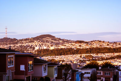 Buildings in town against clear sky