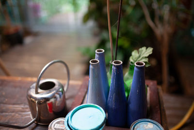 Close-up of bottles and container on table at back yard