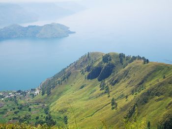 High angle view of sea and mountains against sky