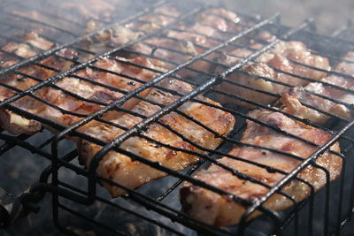 High angle view of meat on barbecue grill