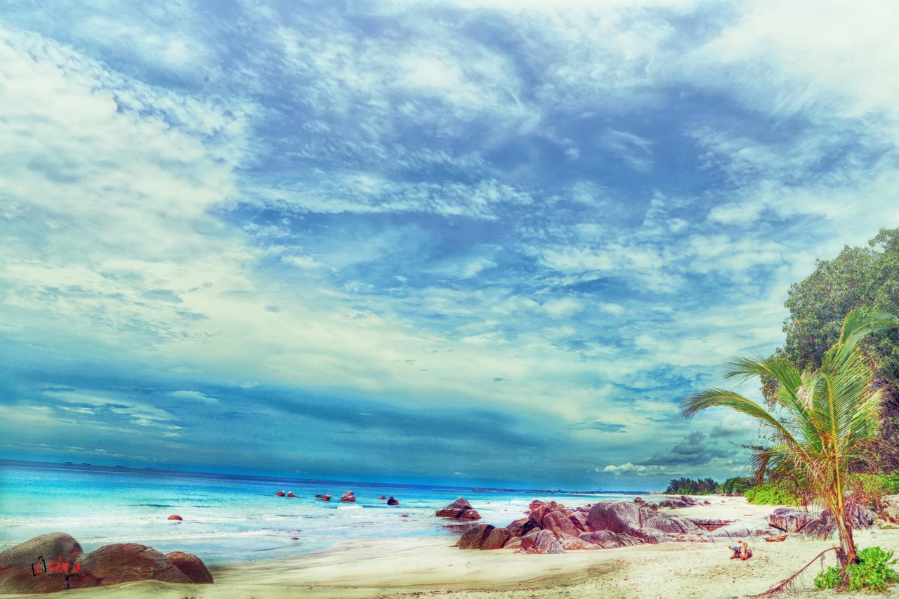 sea, beach, sky, horizon over water, water, tranquil scene, scenics, shore, tranquility, beauty in nature, cloud - sky, nature, sand, idyllic, cloudy, cloud, tree, coastline, rock - object, outdoors