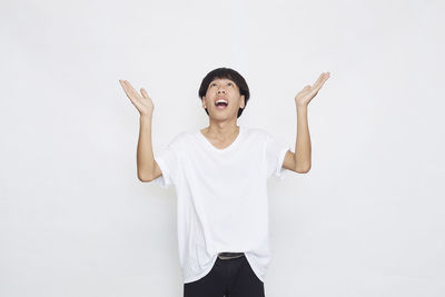 Portrait of smiling man standing against white background