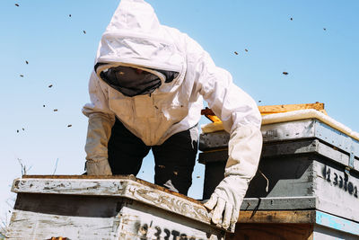 Man working against clear sky