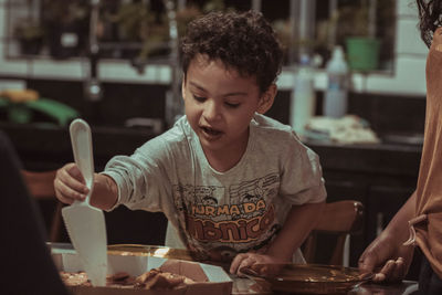 Close-up of boy preparing food at restaurant