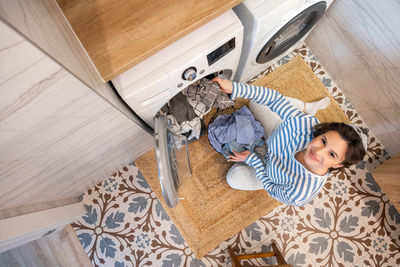 High angle view of cute baby girl sitting at home